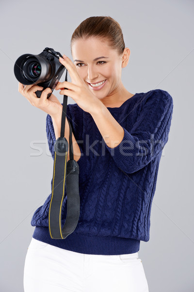 Happy woman holding a professional camera Stock photo © dash