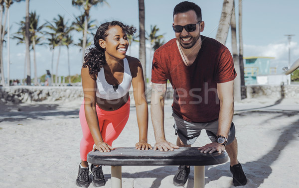 Laughing sportive couple training in beach gym  Stock photo © dash