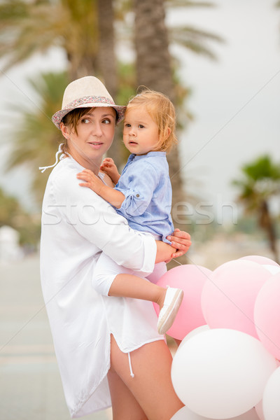 Trendy young mother holding her young daughter Stock photo © dash
