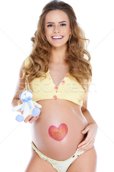Young pregnant woman with heart shape pained Stock photo © dash