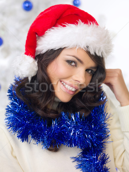 Pretty woman in a festive red Santa Hat Stock photo © dash
