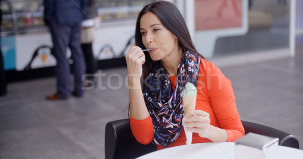 Woman eating an ice cream in a parlor or cafe Stock photo © dash