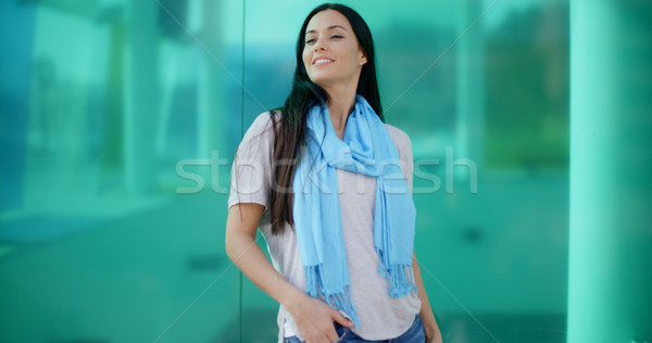 Happy woman looking sideways in front of glass Stock photo © dash