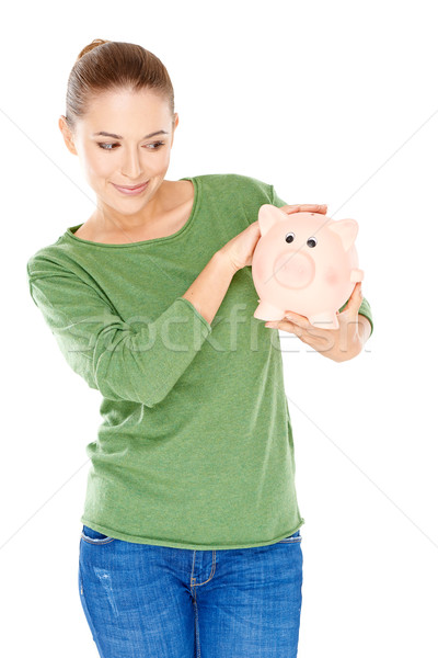 Woman giving her piggy bank a speculative look Stock photo © dash