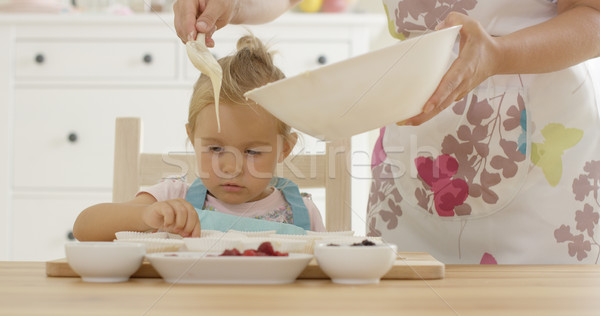 Pouring muffin batter into holders Stock photo © dash