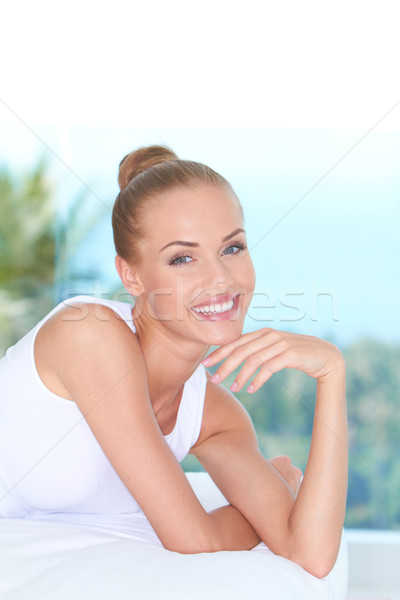 Attractive Smiling Woman Lying Prone on Bed Stock photo © dash