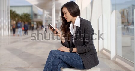 Stylish young woman using her tablet-pc Stock photo © dash