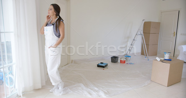 Young woman standing daydreaming at a window Stock photo © dash