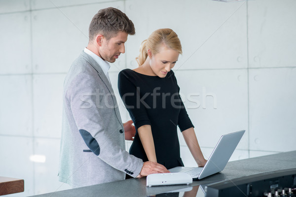 Professional Couple Looking Down at Laptop Stock photo © dash