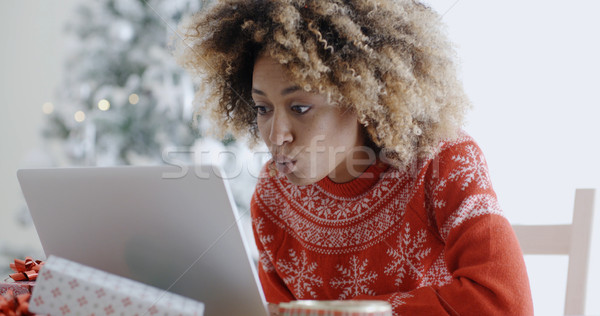 Stock photo: Excited woman shopping online for Xmas bargains
