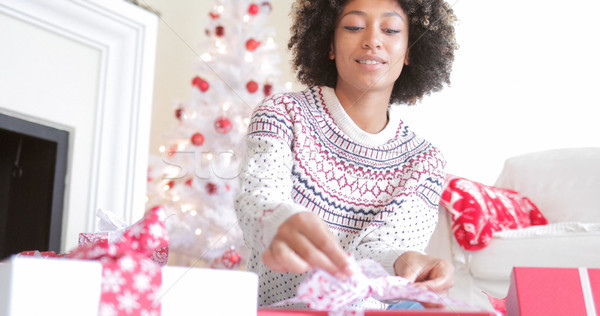 Young woman opening her Christmas gifts Stock photo © dash