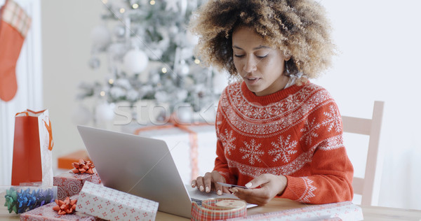 Stock photo: Young woman doing Xmas shopping online