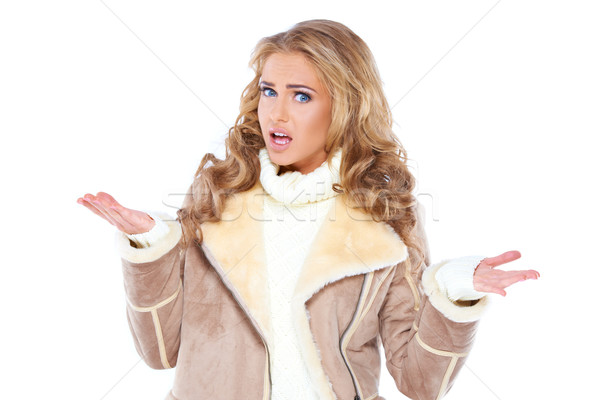 Stylish young woman shrugging her shoulders Stock photo © dash