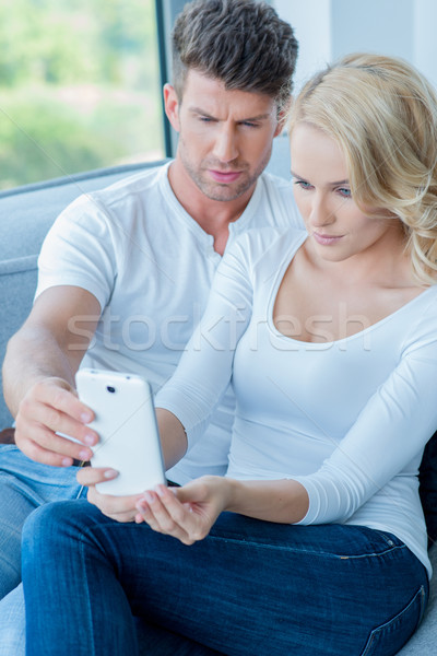 Couple reading a text message with consternation Stock photo © dash
