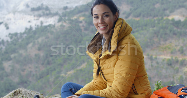 Smiling young woman hiking in the mountains Stock photo © dash