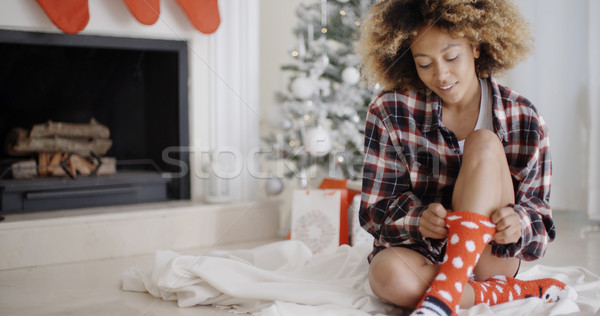 Smiling young woman in a Christmas living room Stock photo © dash