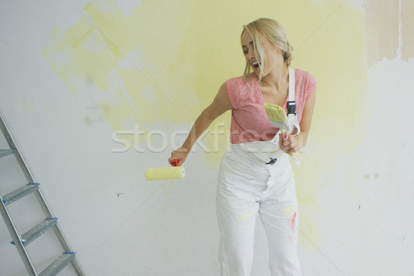 Relaxed woman dancing with paint roller Stock photo © dash