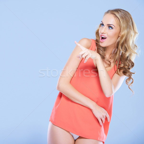 Shocked woman pointing her finger Stock photo © dash