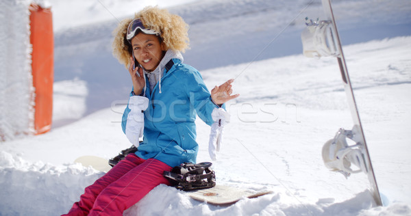 Laughing woman chatting on her mobile in snow Stock photo © dash