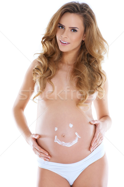 Young pregnant woman with smile shape pained Stock photo © dash