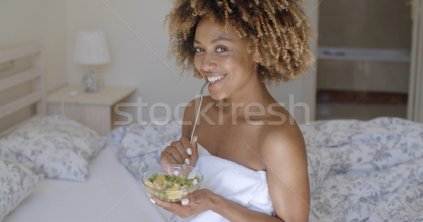 Young Woman On Bed Eating Vegetable Salad Stock photo © dash