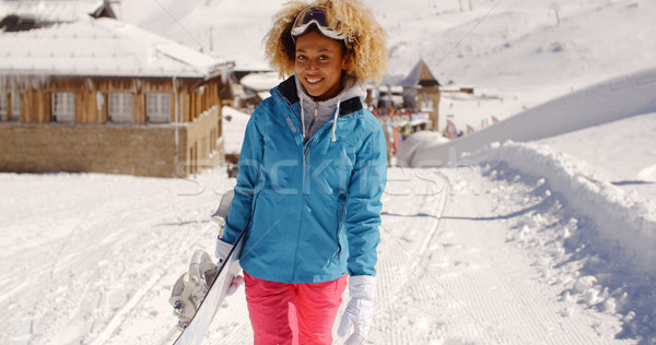 Smiling pretty young woman carrying a snowboard Stock photo © dash