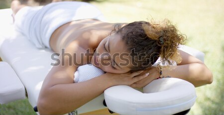 Calm adult female laying down on massage table Stock photo © dash