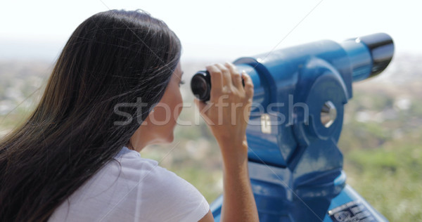 Woman using spyglass on city viewpoint Stock photo © dash
