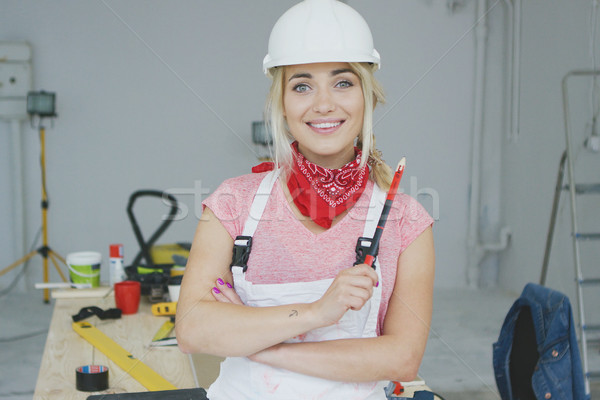 Female construction worker standing at workbench  Stock photo © dash