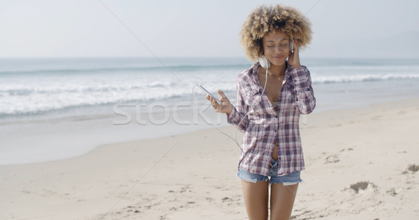 Young Woman Listening To Music At The Beach Stock photo © dash