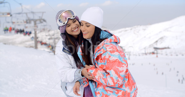 Two happy playful young ladies at a ski resort Stock photo © dash