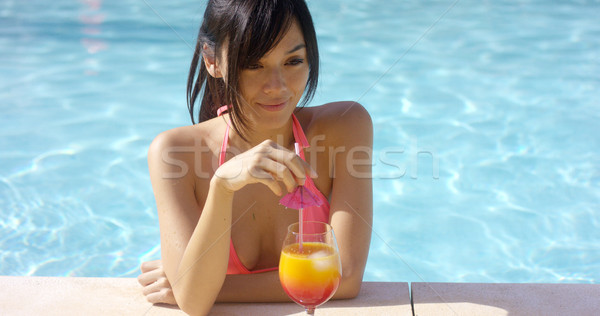 Pretty young woman sipping a tropical cocktail Stock photo © dash