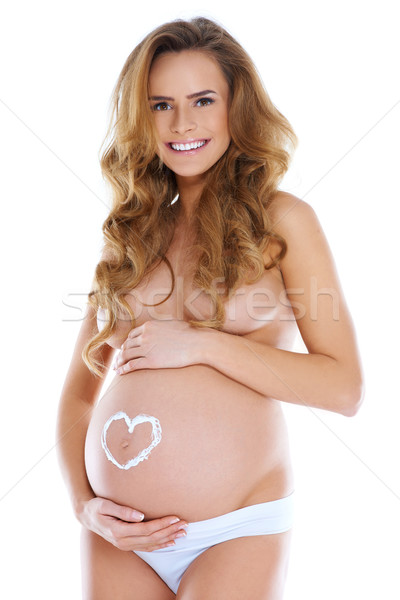 Young pregnant woman with heart shape pained Stock photo © dash