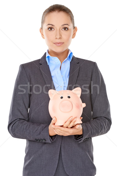 Businesswoman holding a piggy bank Stock photo © dash