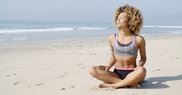 Woman Sitting On The Beach In Lotus Pose Stock photo © dash