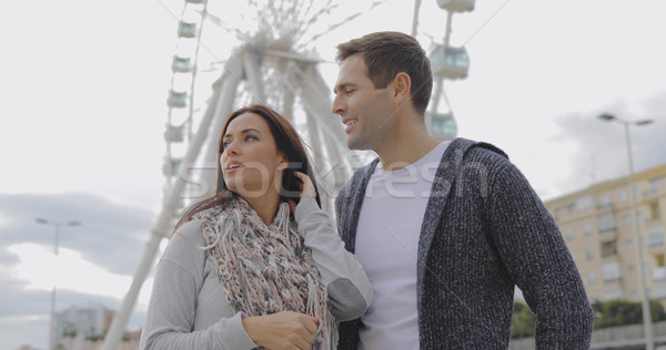 Young couple standing in front of a ferris wheel Stock photo © dash