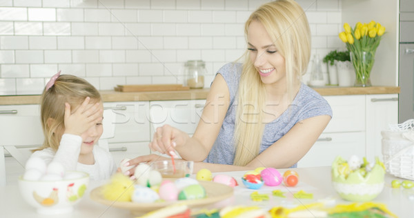 Stock photo: Laughing family coloring eggs