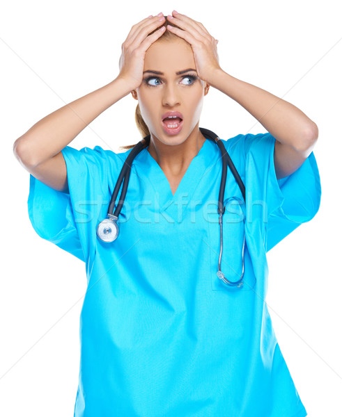 Distressed doctor holding her head Stock photo © dash