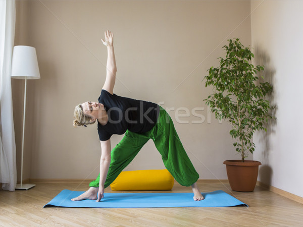 Middle aged woman doing yoga indoors Stock photo © dashapetrenko
