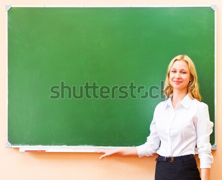 Student girl standing near blackboard in the classroom Stock photo © dashapetrenko