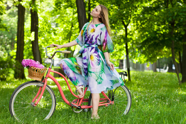 Beautiful blond woman wearing a nice dress having fun in park wi Stock photo © dashapetrenko