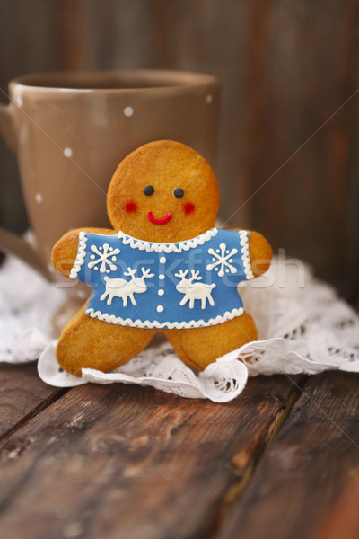 Stock photo: Smiling christmas gingerbread men on wooden background. 