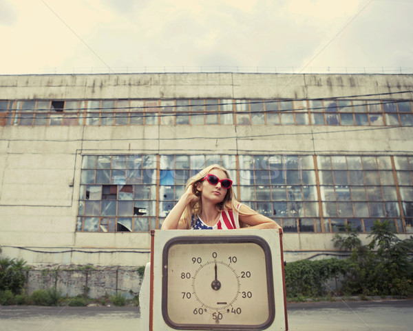 Stock photo: Blond girl on damaged gas station