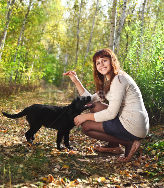 Teenager girl and black labrador retriever puppy  Stock photo © dashapetrenko