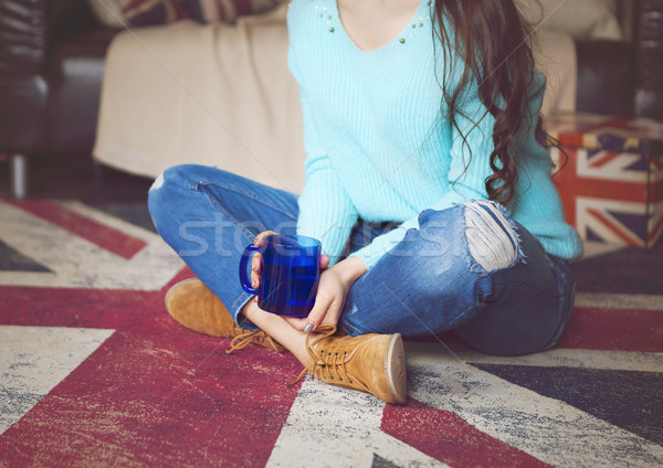 Pretty hipster girl drinking tea near the couch  Stock photo © dashapetrenko