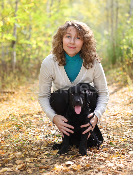 Young woman with black labrador retriever puppy Stock photo © dashapetrenko