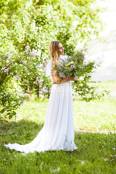 Bride with beautiful wedding bouquet of flowers in the style of  Stock photo © dashapetrenko