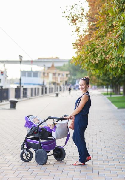 Outdoor portrait of a happy mother and son. Baby sitting in stro Stock photo © dashapetrenko