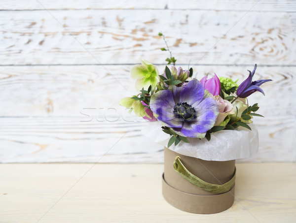 Bouquets of pink and violet flowers in the box on a woden backgr Stock photo © dashapetrenko
