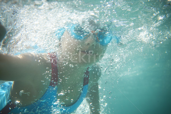 Little girl swims in the pool underwater Stock photo © dashapetrenko